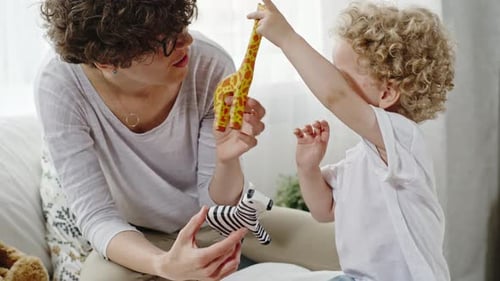 Woman and Child Playing with Toys at Home