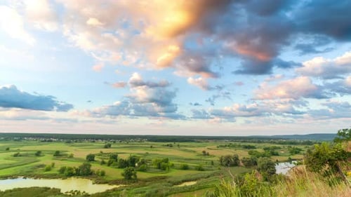 A Beautiful Valley with a River, Blue Sky with Large Clouds and Bright Sun. Aerial UHD