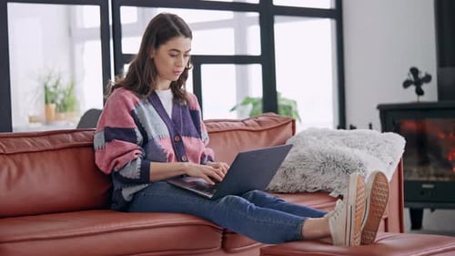 Young Adult Woman Using Laptop on Couch