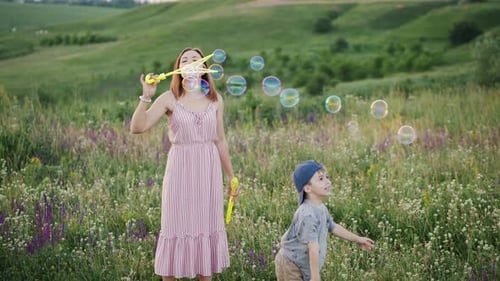 Mother and Child Playfully Blowing Soap Bubbles