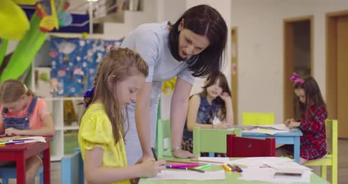 Creative Kids During an Art Class in a Daycare Center or Elementary School Classroom Drawing with