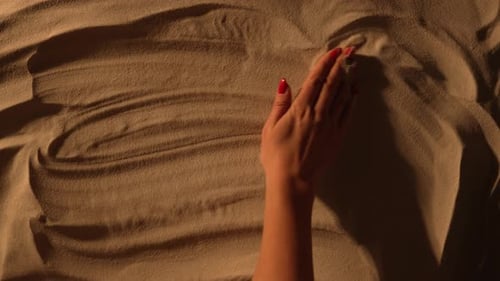 Female Hand Smoothing the Sandy Surface and Drawing Inscription Beach