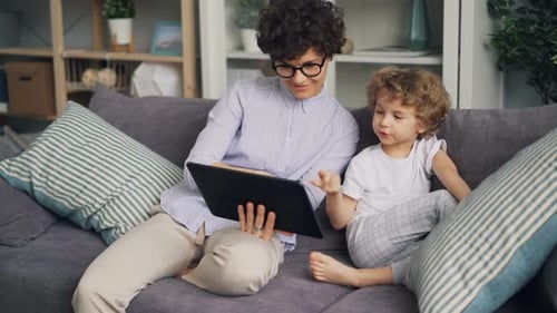 Mother and Son Watching Tablet Together on Sofa