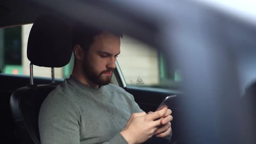 Man Using Smartphone in Car