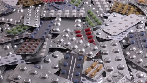 Heap of medication blister packs close up