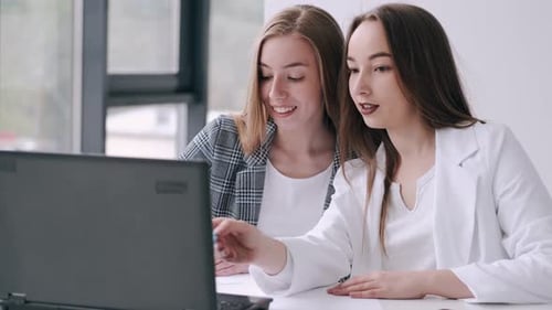 Two Women in the Office with a Laptop
