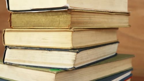 Stack of Vintage Books on Wooden Table