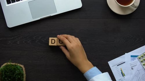 Doctor Blocks Spelled Out on Dark Wooden Desk