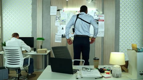 Back View of Detective Thinking in Front of Board