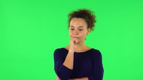 Portrait of Curly Woman Focused Thinks About Something, No Idea. Green Screen