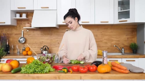 Woman Cutting Vegetables on Kitchen Island