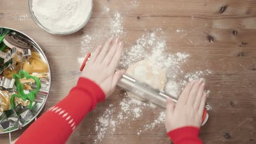 Rolling Pin Flattening Cookie Dough at Wooden Table