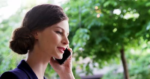 Woman Talking on Phone Outdoors in the City