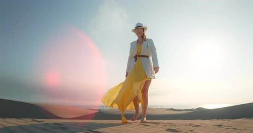 Stylish Lady Walking Barefoot on Sand Dune with Lense Flare