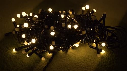 Closeup Shot Hank of Christmas Garland with Golden Lights on a Playd