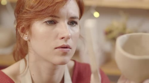 Woman Crafts Pottery Bowl in a Studio