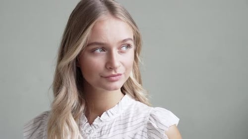 Smiling Woman with Blonde Hair Posing Indoors