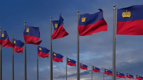 Waving Liechtenstein Flags Against Blue Sky