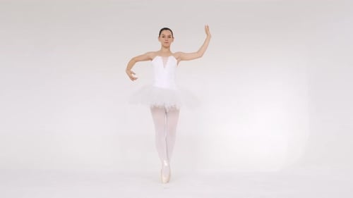 Woman Dancing Gracefully in Ballet Studio