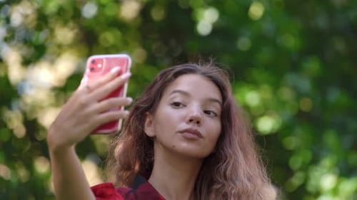 Beautiful Woman Taking Selfie in a Green Park