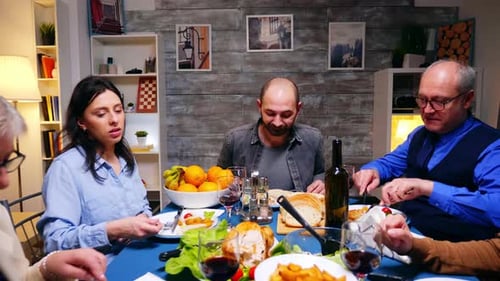 Family Dinner Around a Table Sharing Food