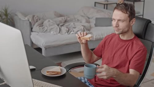 Adult Man Working from Home Eating Breakfast