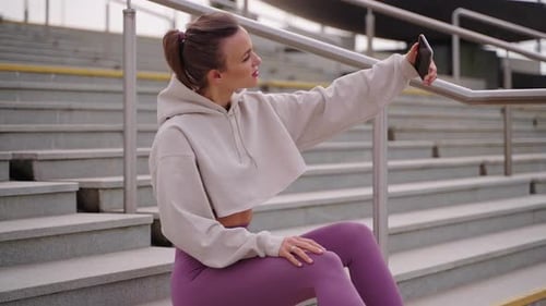 Young Woman Taking Selfie on Urban Stairs