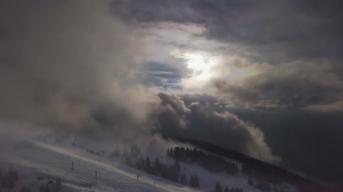 Dramatic Mountain Sunlight Over Snow-Capped Range