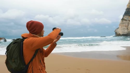 Photographer Takes Picture of Distant Cliffs on Ocean Beach