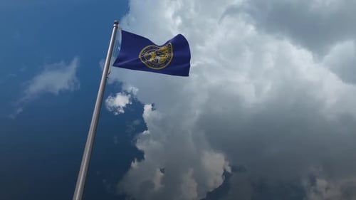 Nebraska State Flag Waving in Realistic Cloudy Sky