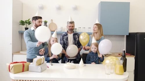Family Celebrates a Birthday with Balloons