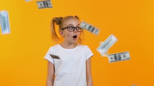 Girl Expresses Shock as Money Falls Around Her