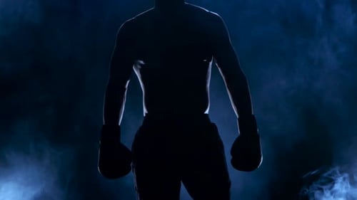 Boxer Shows That He Is Ready To Fight. Dark Background