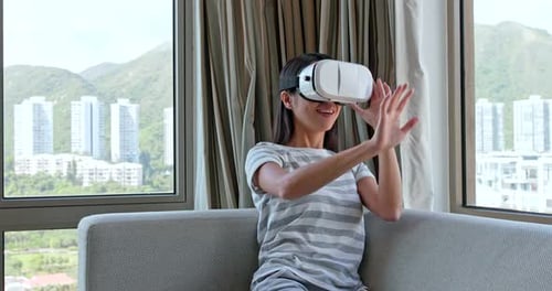 Woman Experiencing Virtual Reality Headset in Apartment