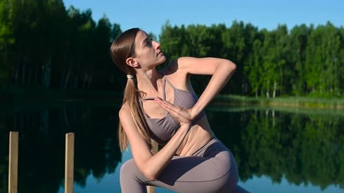 Yoga Outdoor Asana Practice at Sundown on a Pier at a Lake By Sport Calm Girl.
