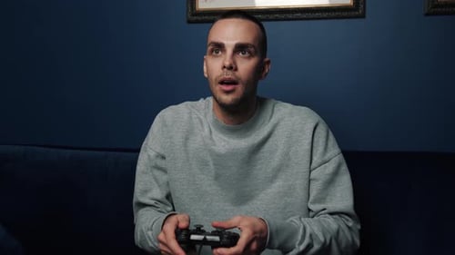 Young Adult Playing Video Games and Celebrating Victory