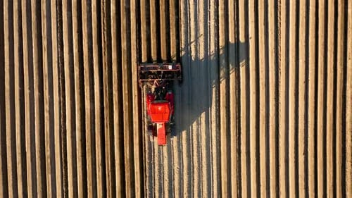 Aerial View of Tractor Performs Seeding on the Field