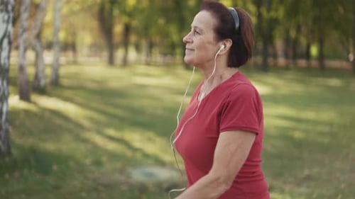 Elderly Woman Walking Fast at the Park