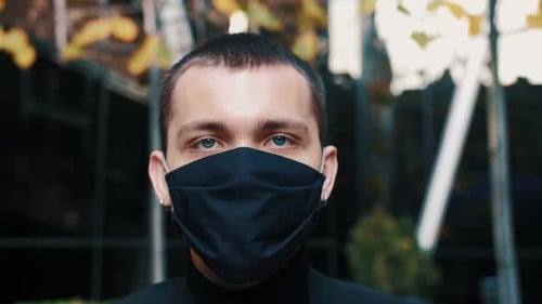 Young Adult Wearing Mask Looking at Camera