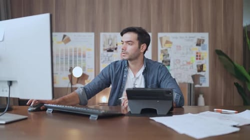 Man Working at Computer in Modern Workplace