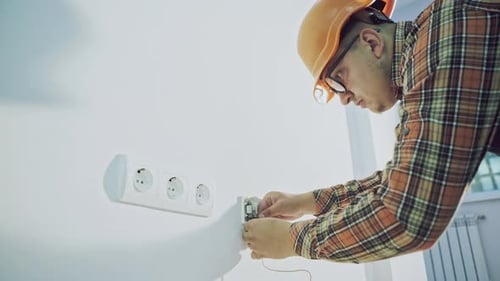 Technician Connects Circuit Board in Modern Interior