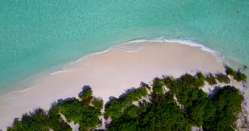 Daytime above tourism shot of a summer white paradise sand beach and blue water background in colorf