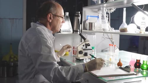 Scientist Examining Test Tubes in Bright Laboratory