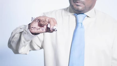 Man Writes Mission Accomplished on Clear Surface