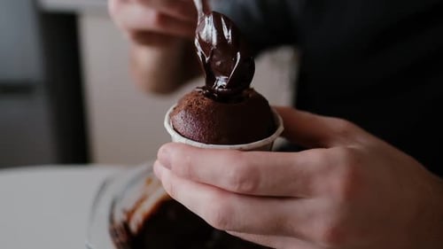 Adding Chocolate Sauce to a Delicious Homemade Cupcake