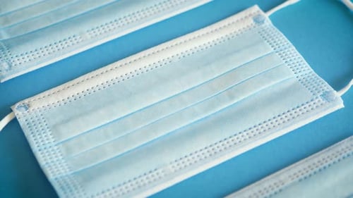 Surgical Masks on Blue Background in Close Up