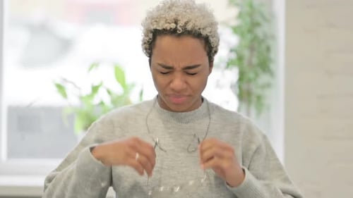 Young Adult Experiencing Headache Rubbing Temples