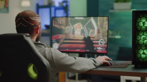 Young Adult Playing Video Game on Computer