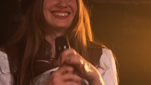 Emotional Live Performance of a Female Vocalist with a Rock Band