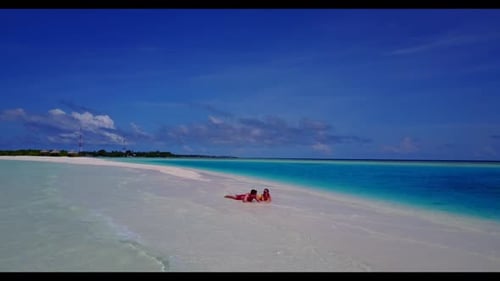 Boy and girl posing on idyllic sea view beach break by blue sea and white sandy background of the Ma